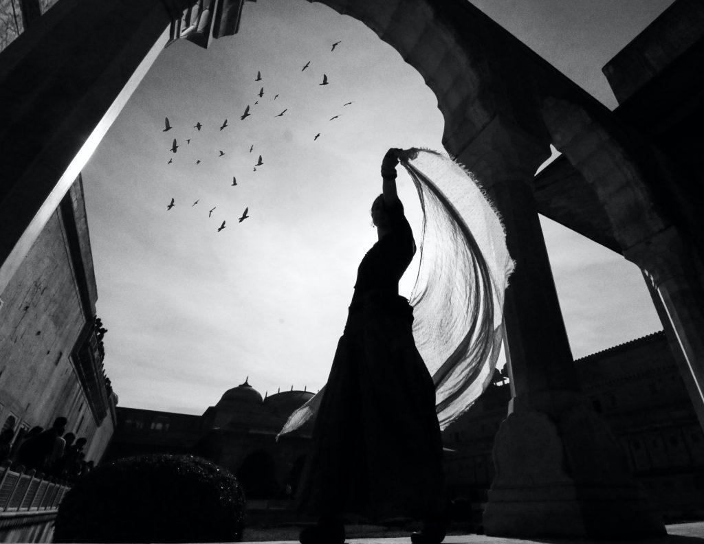 low-angle-view-of-silhouette-of-woman-standing-near-building